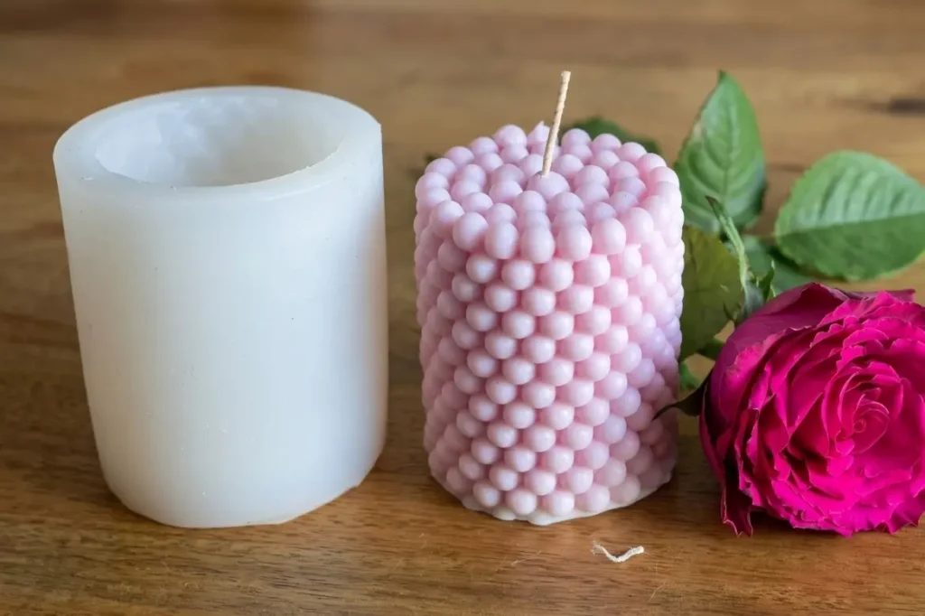 Bubble cube candle made using silicone candle mould on wooden craft surface