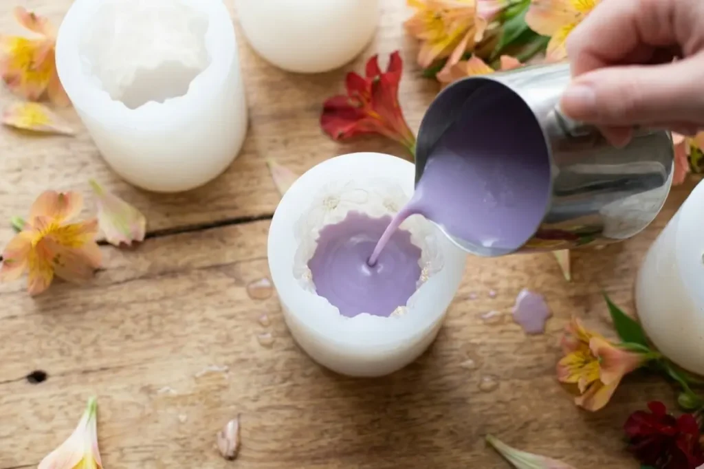 pouring soy wax into a flower candle mold for candle making