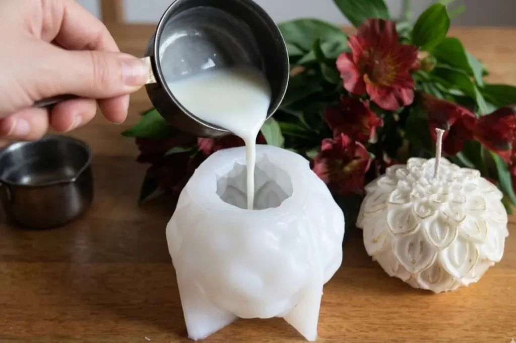 Pouring melted wax into lotus candle mold silicone during candle making