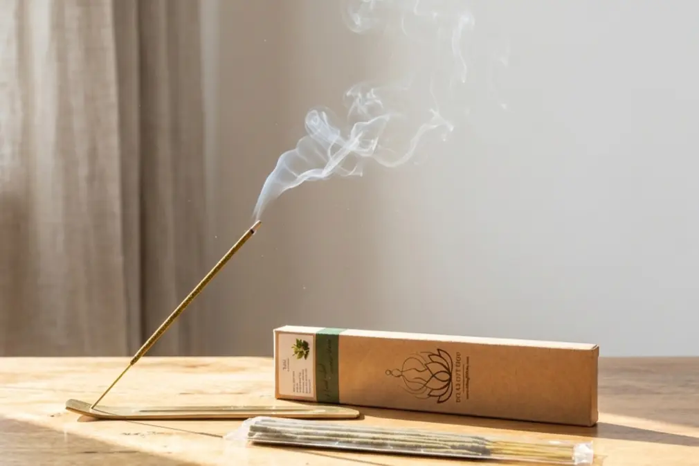 Sunlit clean room with incense smoke for air purification showing herbal incense benefits of tulsi